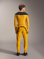 Alpinestars Limited Edition A-Supra Melt Gold Jersey, Long Sleeve MTB Jersey, Dark Yellow, back view, featuring black shoulder panels, worn with matching yellow pants with large black branding on the rear, performance cycling gear