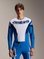 Alpinestars A-Supra Melt Jersey Long Sleeve, Blue and White MTB Jersey, featuring bold astars branding across the chest, dark blue sleeves, worn with matching blue racing pants with white star logos, performance mountain bike apparel
