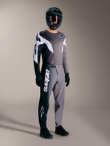 A-Supra Elite Jersey, Faded Gray long-sleeved MTB racing top with black and white accents on a rider in full gear.