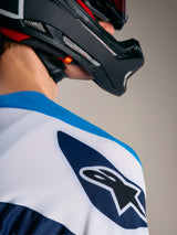 A-Supra Elite Jersey in Faded Bright Blue, featuring the white Astars logo on the shoulder and a black MTB helmet.