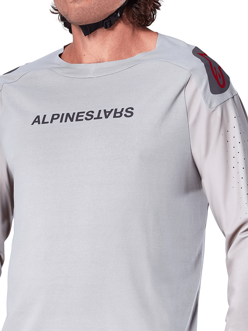 Close-up of the Alpinestars A-Aria Polartec Switch Long Sleeve Jersey in Light Gray, featuring Alpinestars chest branding, red shoulder logo, and laser-perforated sleeves for airflow, premium mountain bike gear.