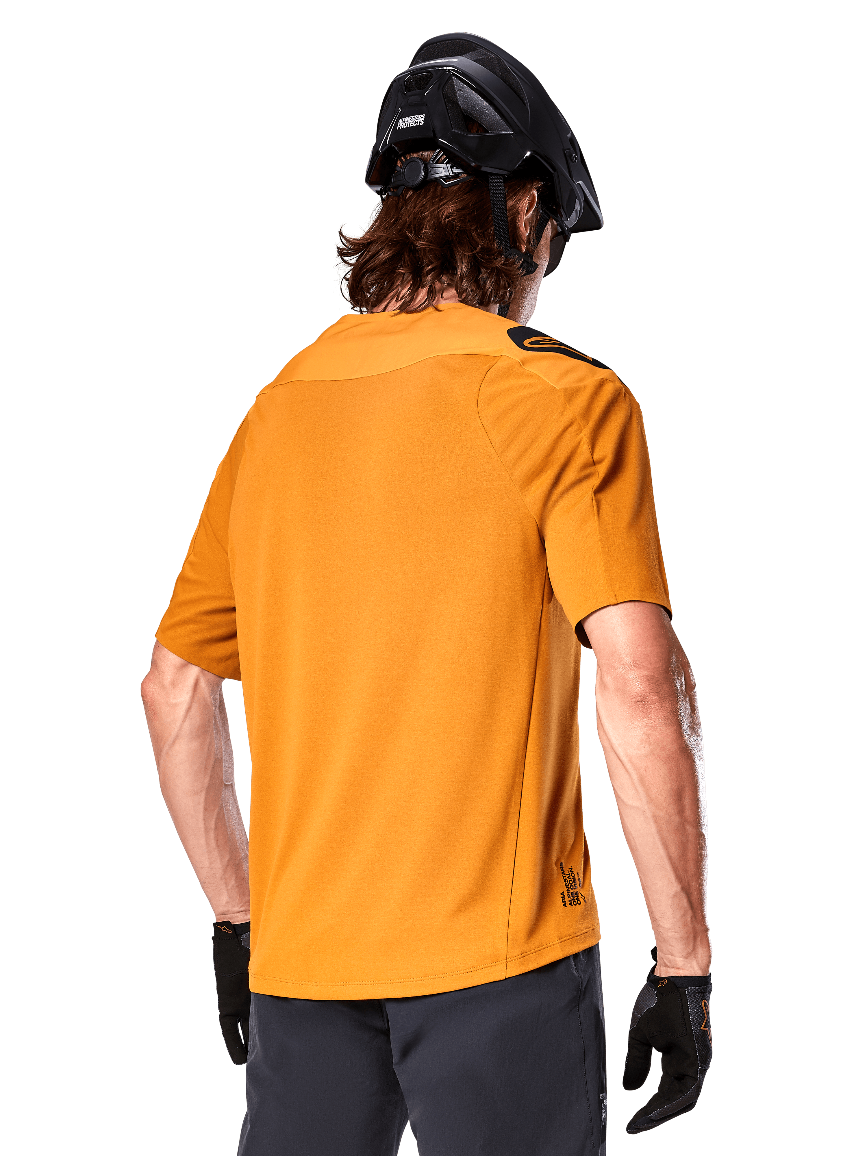 Alpinestars A-Aria Polartec Switch Jersey, Short Sleeve MTB Jersey, Dark Gold, back view showing performance fit, worn with black helmet and grey shorts, durable and breathable trail riding apparel
