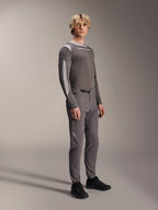 Alpinestars A-Dura Elite Pants, Mountain Bike Pants, Dark Gray, worn with a matching long-sleeve jersey and black shoes, featuring a front ratchet closure and durable Cordura fabric for trail and enduro riding
