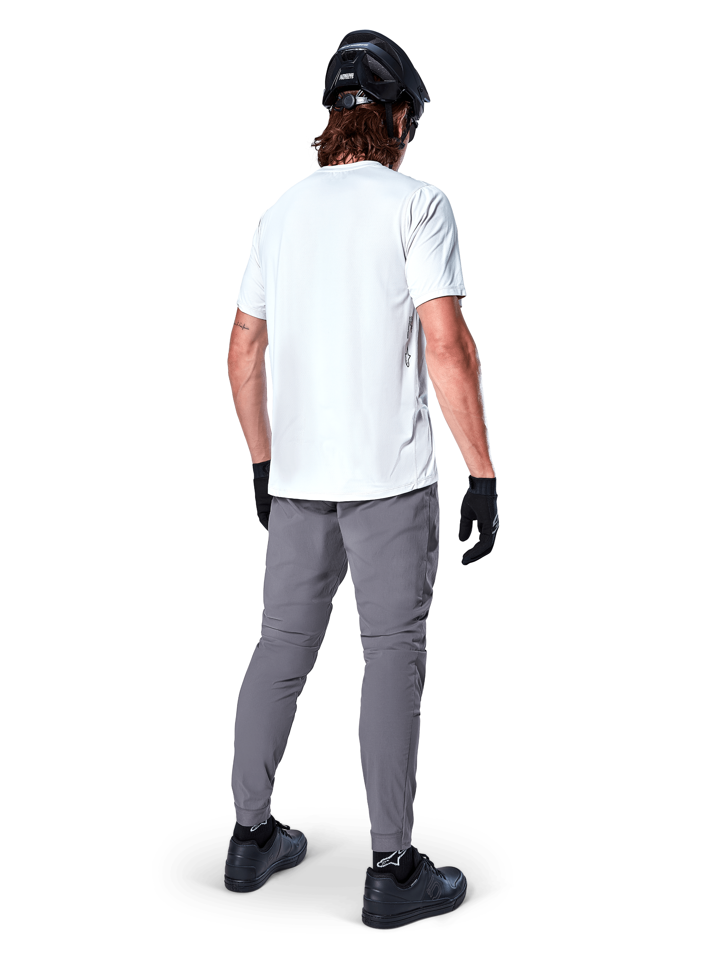 Alpinestars A-Dura Oscar Short Sleeve Jersey in White Dove, back view worn by a rider with grey cycling pants, black helmet, and gloves, technical mountain bike apparel for off-road trail riding