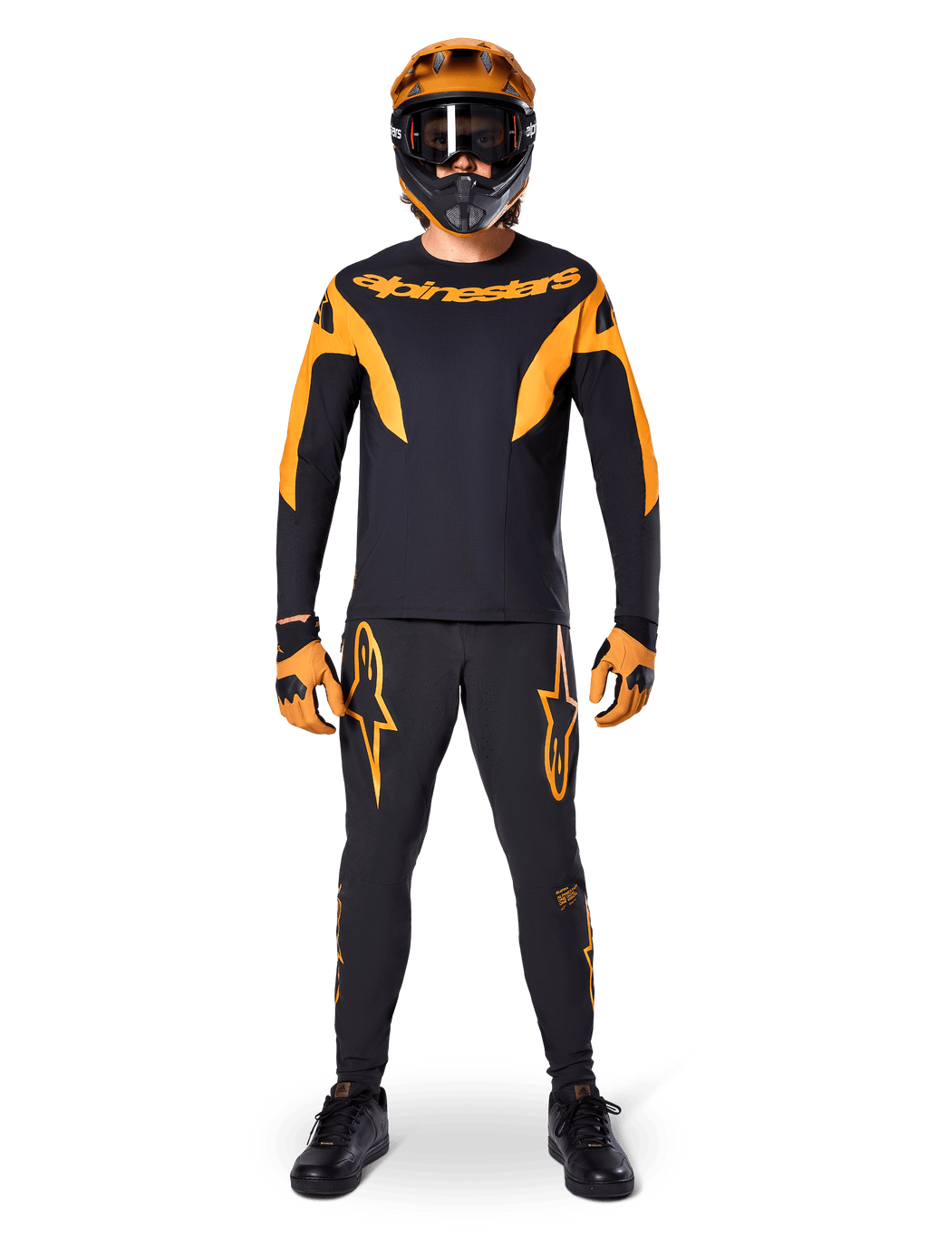 MTB rider wearing Alpinestars A-Supra Race Jersey - Long Sleeve in Black and Orange, matching black and orange pants, gloves, and a full-face helmet with goggles, coordinated mountain bike kit for racing and off-road performance