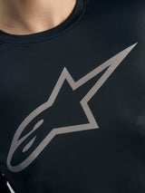 Grey Alpinestars logo detail on a black Stella A-Dura Ride Long Sleeve Jersey, featuring women's MTB jacquard fabric.