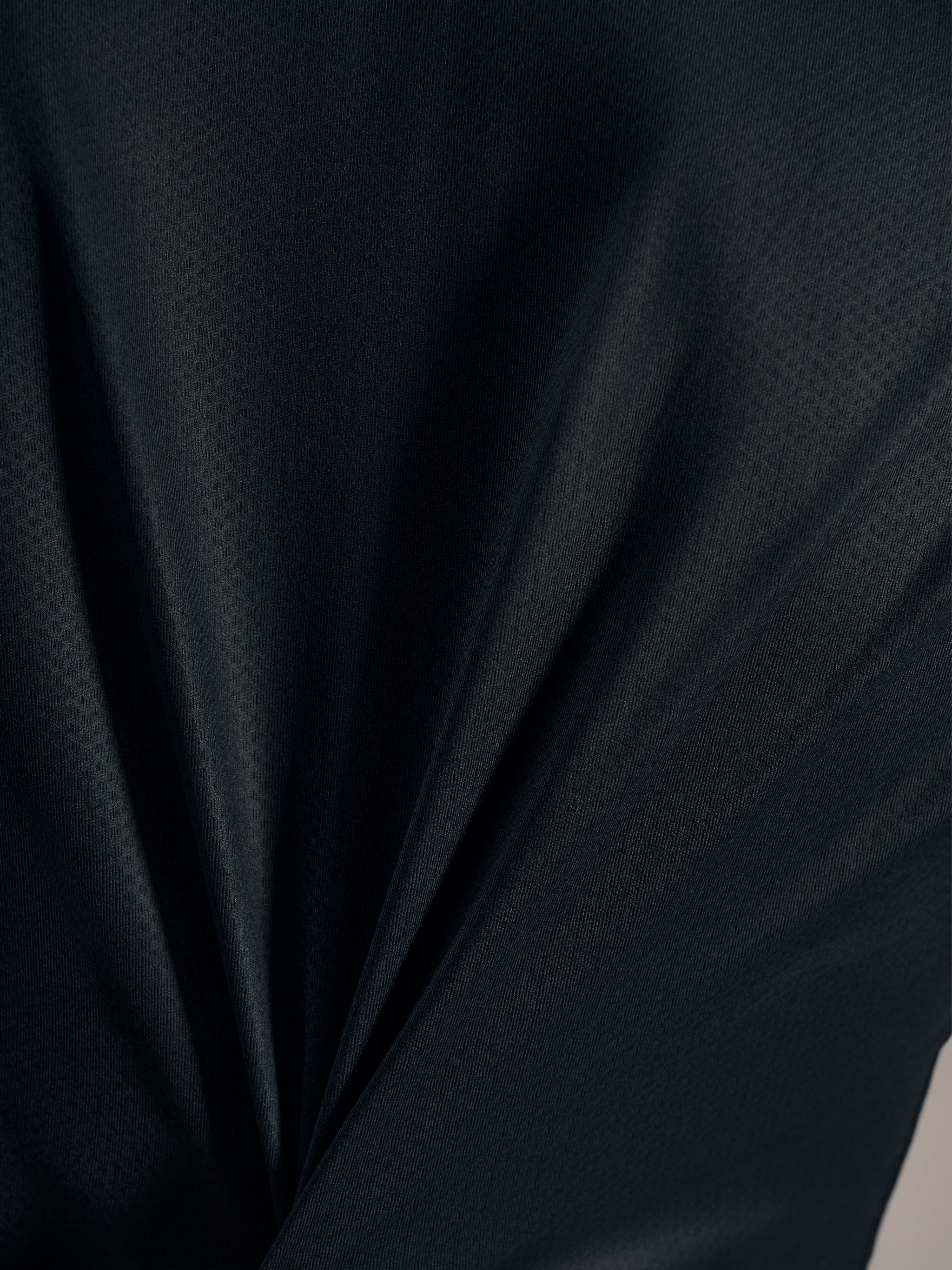 Black jacquard fabric detail on the Stella A-Dura Ride Jersey, highlighting its breathable texture and high-performance stretch.