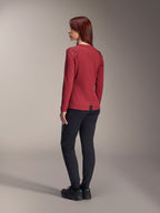 Woman wearing Alpinestars Stella A-Dura Thermal Pants in Black, paired with a red long-sleeve thermal jersey and black shoes, rear view, mountain bike apparel for cold-weather riding.
