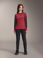 Alpinestars Women Stella A-Dura Dri Astar Long Sleeve Jersey in Burgundy, featuring a black Astars logo on the chest and black mesh arm panels, styled with black technical pants and athletic shoes, performance mountain bike apparel for women.