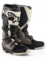Alpinestars 2026 Tech 7 Enduro Drystar® Boots, Motocross and Enduro Boots, Black Dark Gray and Gold, featuring a rugged TPU shell, quick-release aluminum buckles with gold accents, and a large white shin plate with a black logo, designed for off-road durability.