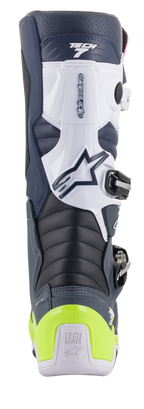 Alpinestars Tech 7 Boots, Motocross Boots, rear view showing Dark Blue, White, and Dark Gray colorway with bright yellow-fluo heel protector, featuring accordion flex zones and Tech Series branding.