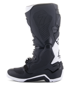 Alpinestars Tech 7 Enduro Drystar® Boots, Enduro Motorcycle Boots, Black and White, medial side view featuring honeycomb textured grip panels, TPU construction, and white accents on the heel and upper calf, professional off-road footwear