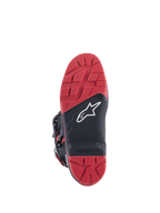 Honda Tech 7 Enduro Drystar® Boots, Black and Bright Red, sole view showing high-grip tread pattern with replaceable insert, dual-density rubber construction, and white Alpinestars logo on black textured panel.