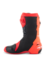 Alpinestars Supertech R Boots, professional motorcycle racing boots, Bright Red and Red Fluo with black panels, side profile view showing the TPU shin plate, flexible rear accordion design, and white Alpinestars logo on the heel