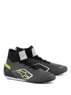 Alpinestars Supertech Shoes, Auto Racing Footwear, Cool Gray and Black with Fluo Yellow accents, featuring a knitted aramidic upper, carbon fiber heel cup, and white FIA certification labels on the tongue, professional motorsport design