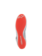 Alpinestars Tech-1 Z V3 Shoes FIA, Auto Racing Shoes, Dark Silver Black Red, Bottom view showing the bright red rubber outsole with white Alpinestars logos, textured asymmetric tread pattern for grip, silver leather accents on the side