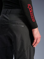 Alpinestars C-1 Air Pants, Black textile motorcycle pants, close-up view of the back pocket with a subtle grey Alpinestars logo, featuring breathable mesh panels and durable polyfabric, designed for urban riding comfort