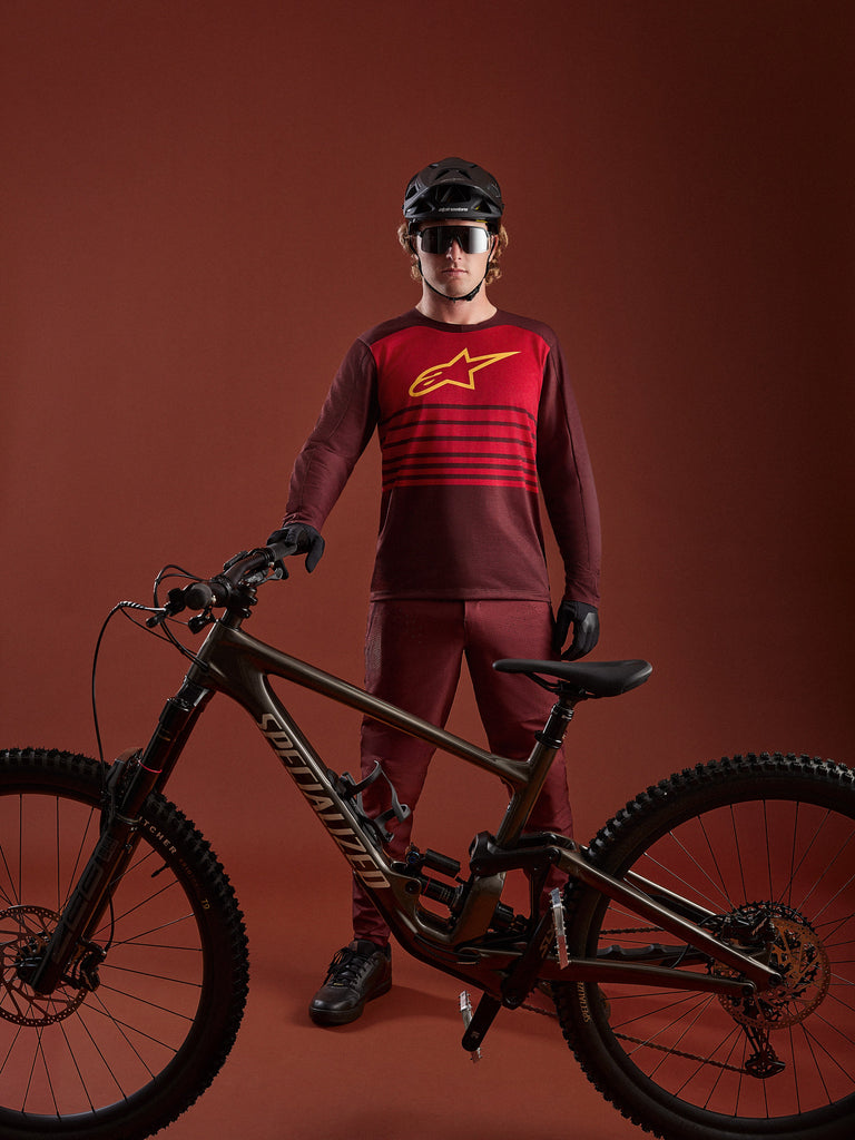 Bordeaux A-Dura Elite Jersey 2.0, long sleeve MTB jersey with red chest panel and yellow logo, shown with mountain bike.