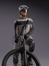 Gray Alpinestars A-Dura Race Long Sleeve Jersey on an MTB rider, featuring black accents and professional cycling gear.