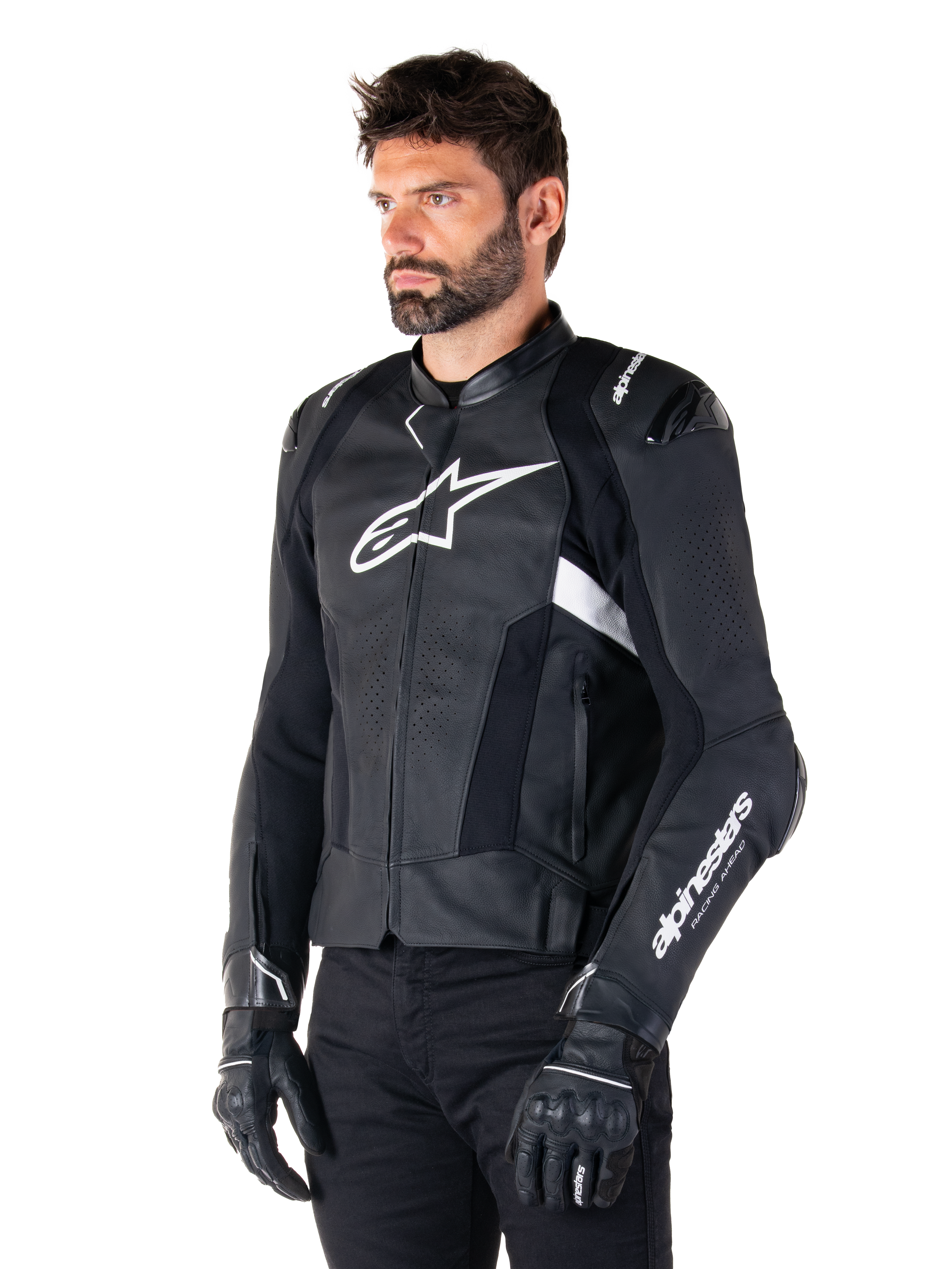 Man wearing the Alpinestars Missile V3 Airflow Leather Jacket, Black and White motorcycle jacket, premium perforated leather for airflow, white Alpinestars logo on chest and sleeve, racing-inspired sport fit, worn with black gloves and pants.