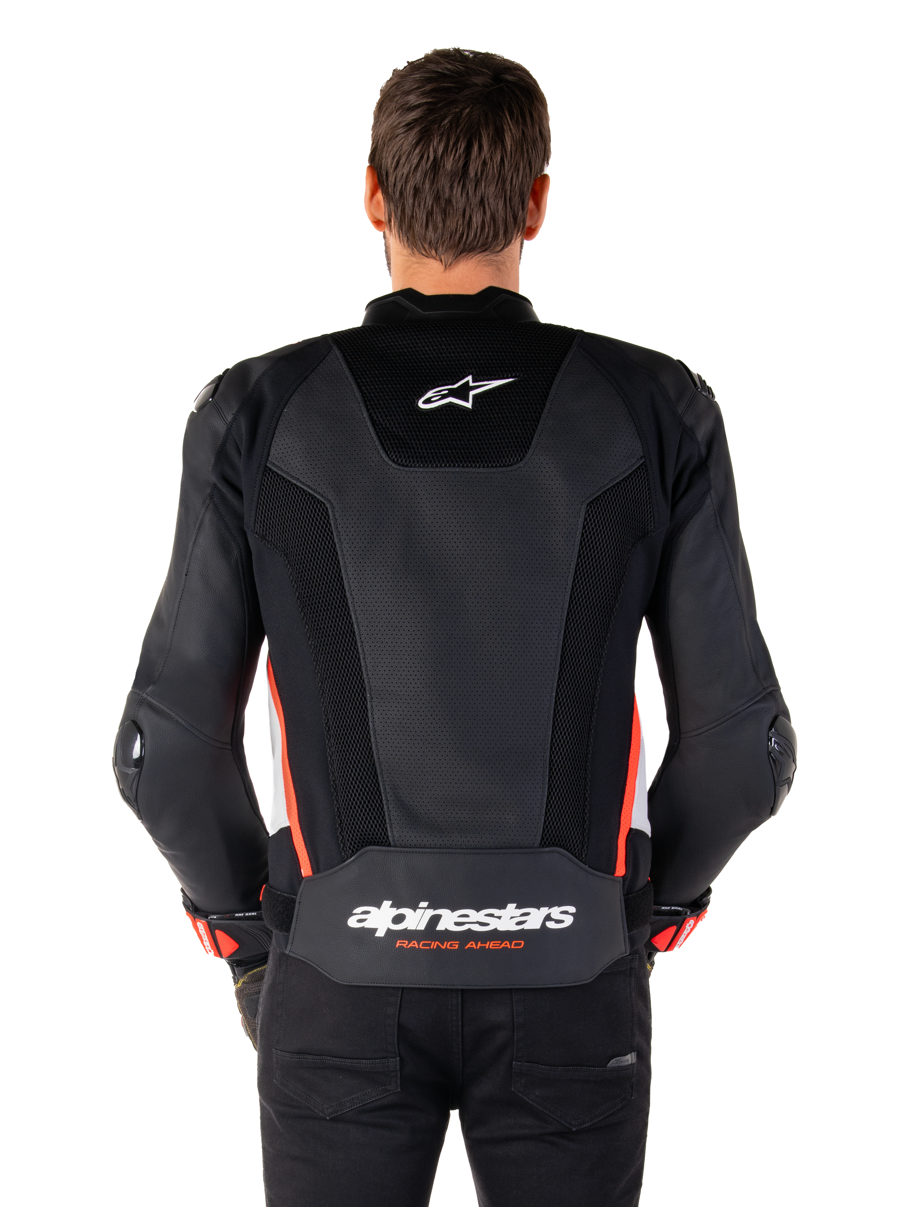 Rear view of a person wearing the Alpinestars Missile V3 Airflow Leather Jacket in Black White Red Fluo, featuring extensive perforated leather panels for ventilation, a small Alpinestars logo on the upper back, and bold 'alpinestars RACING AHEAD' branding on the lower waist.