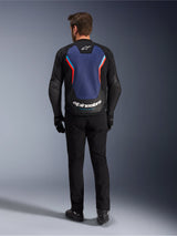 Alpinestars GP Force V2 Leather Jacket, Sport Motorcycle Jacket, Black Blue Red Fluo, back view on a model, featuring a large blue back panel with red and light blue accents and white Alpinestars branding at the lower back, paired with black riding pants and gloves.