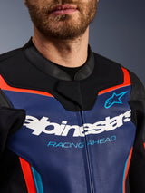 Alpinestars GP Force V2 Leather Jacket, detail view of chest and collar, Blue Black and Red Fluo, featuring white Alpinestars logo and light blue 'RACING AHEAD' text, premium leather texture with fluorescent accents