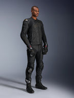 Male model wearing Alpinestars Missile V3 Leather Pants and matching black leather jacket with gold accents, black GP Pro racing gloves, and black racing boots, complete motorcycle racing gear for road use, studio shot.