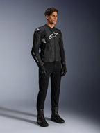Alpinestars Dusk Airflow Leather Jacket, Black and White, modeled with black motorcycle pants, gloves, and boots, featuring perforated leather panels and white logo branding, sport road racing style.