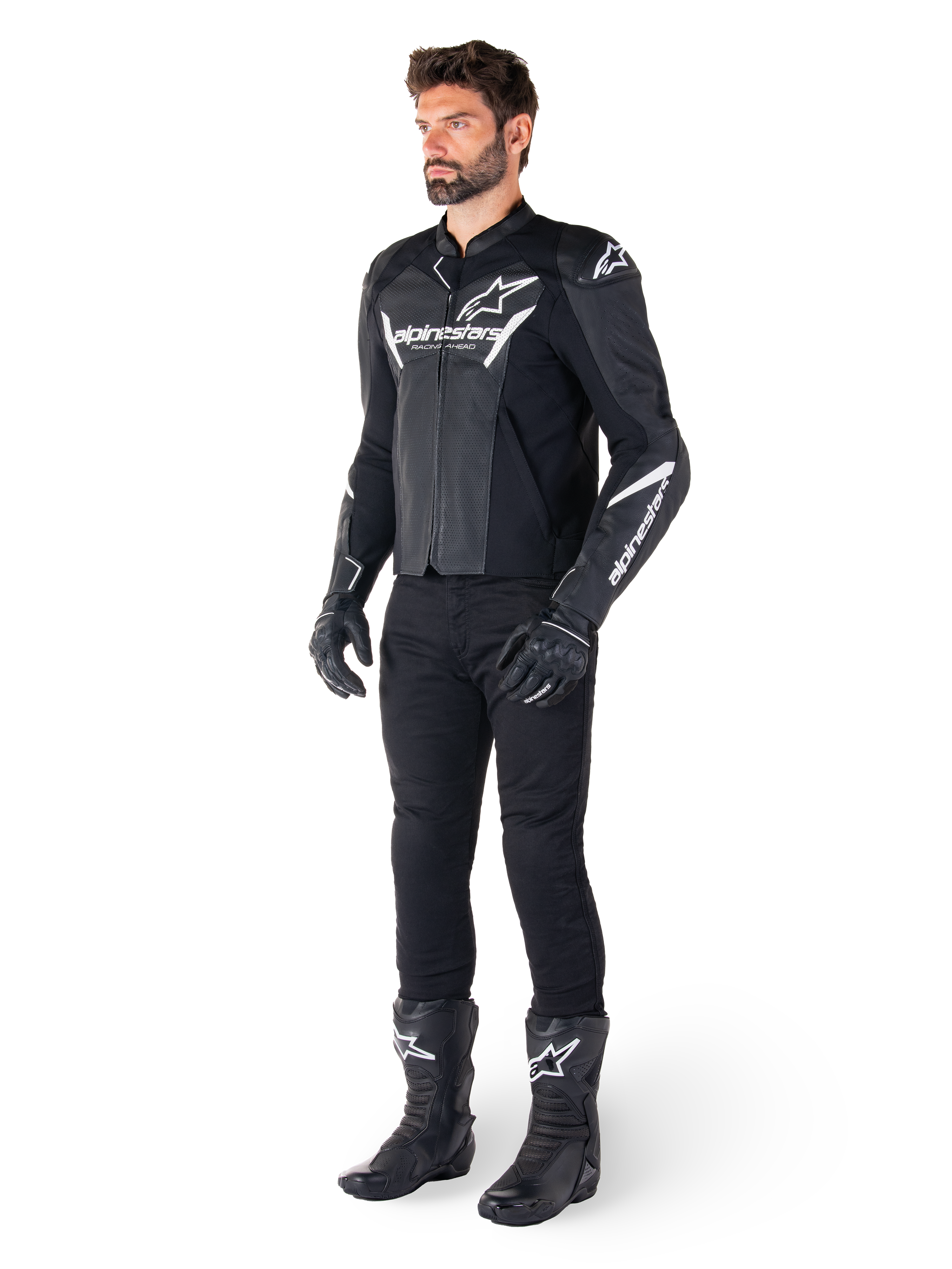 Model wearing Alpinestars Faster V3 Airflow Leather Jacket, Black and White, featuring perforated leather and white Alpinestars logos, paired with black riding pants, gloves, and boots, sport-focused motorcycle gear