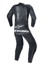 Alpinestars Youth GP Plus V2 1-Piece Leather Suit, Black, back view featuring an aerodynamic hump, white Alpinestars logo and text on the lower back, 'RACING AHEAD' side branding, and accordion stretch panels for mobility.