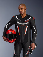 Alpinestars GP Force V2 Leather Suit, 1-Piece Motorcycle Suit, Black White and Red Fluo, worn by a model holding a red helmet and gloves, sleek racing design with perforated leather and bold branding