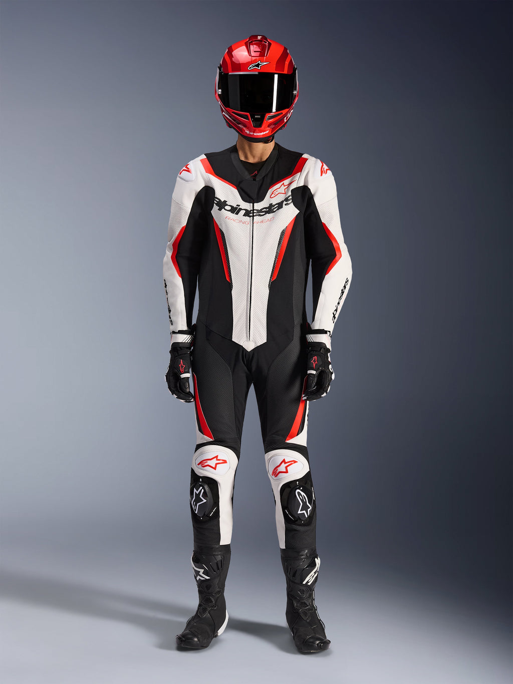 Alpinestars GP Force V2 Leather Suit - 1Piece, White Black and Red Fluo, full racing gear including red helmet, black gloves and boots, featuring aerodynamic design and Alpinestars branding on chest and knees