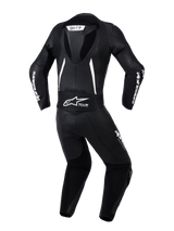 Alpinestars Woman Stella GP-R7 2-Piece Leather Suit, back view in Black with white accents, featuring an integrated aerodynamic hump, accordion stretch panels on shoulders and lower back, perforated leather for ventilation, and prominent Alpinestars branding.