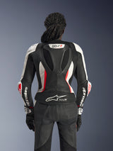 Rear view of the Alpinestars Stella GP-R7 2-Piece Leather Suit in Black White and Red Fluo, featuring an aerodynamic race hump with GP-R7 branding, perforated leather panels, accordion stretch zones, and Tech-Air® Ready logo on the lower back.