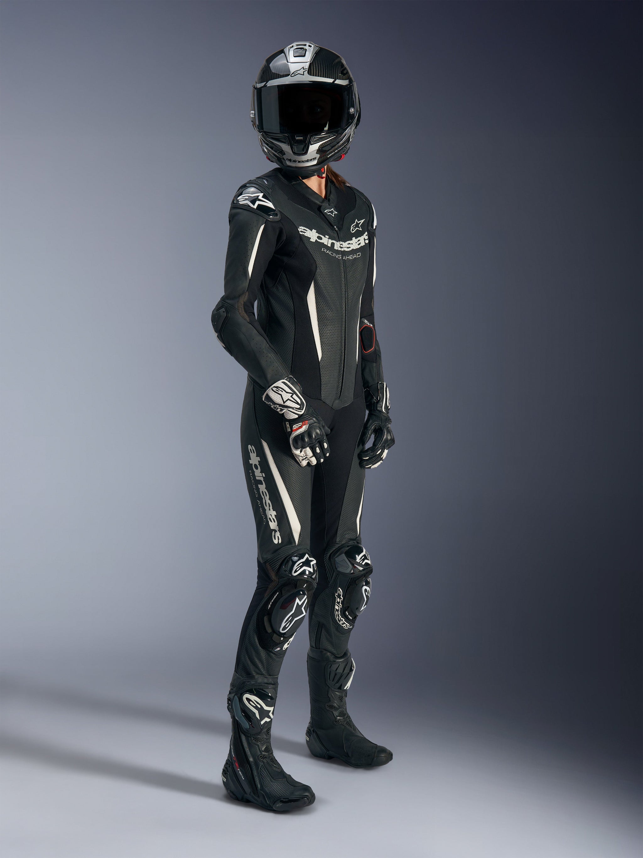 character in suit and motorcycle helmet Stella GP-R7 1PC - Black Motorcycle Suit