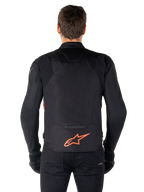 Alpinestars T-Jaws V4 Waterproof Jacket, Rear View, Black with Red Fluo, featuring a red Alpinestars logo on the lower back, technical textile construction, worn with black pants and gloves for a complete sport riding look