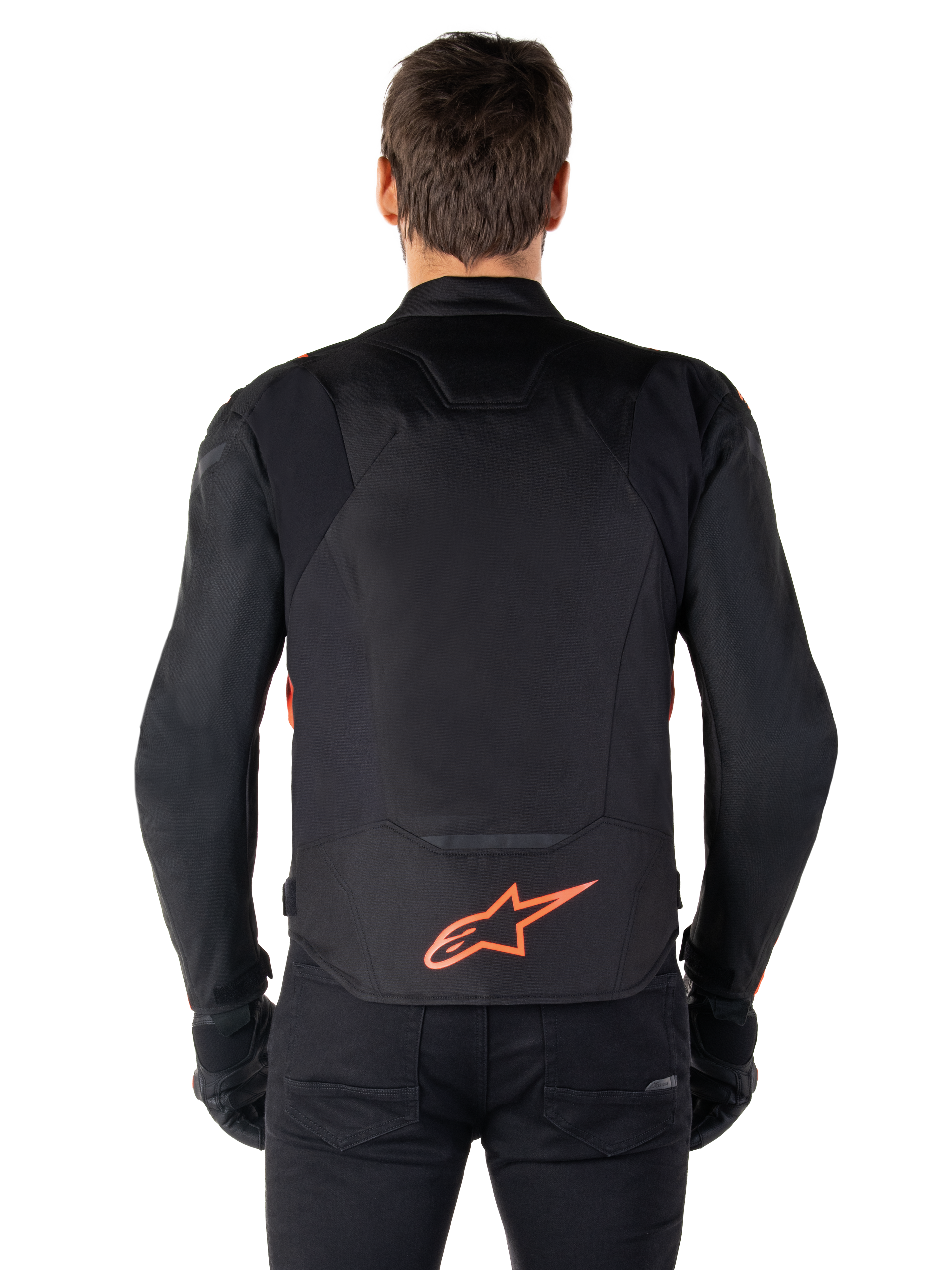 Alpinestars T-Jaws V4 Waterproof Jacket, Rear View, Black with Red Fluo, featuring a red Alpinestars logo on the lower back, technical textile construction, worn with black pants and gloves for a complete sport riding look