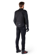 Alpinestars T-Jaws V4 Waterproof Jacket, Black, rear view on model wearing black riding pants and boots, showcasing the sport textile construction and Alpinestars logo on the lower back.