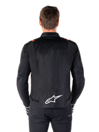 Alpinestars T-SPS V2 Waterproof Jacket, Black with White and Red Fluo accents, rear view featuring a large white Alpinestars logo on the lower back, sport cut textile motorcycle jacket, worn with black pants and gloves