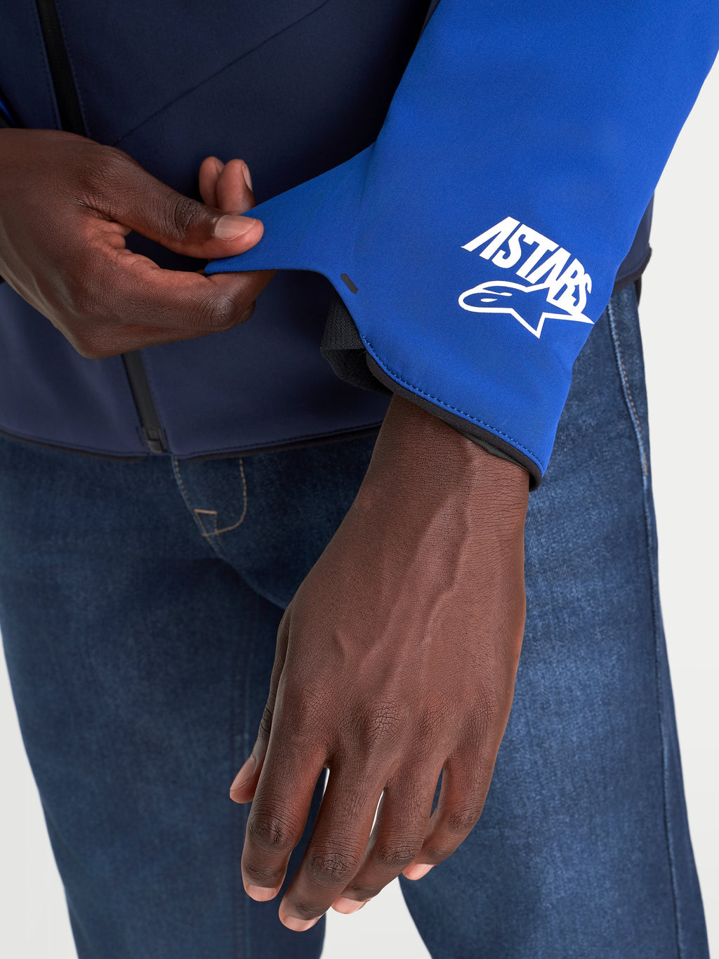 Alpinestars Aeroshell Waterproof Jacket, close-up view of the sleeve cuff detail showcasing the A-stars logo, Night Navy and Bright Blue, men's motorcycle textile jacket
