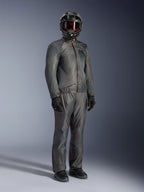 Rider wearing the Alpinestars Borrego Drystar® Jacket in Warm Gray, full-body adventure gear with matching gray pants, black full-face helmet with goggles, and black gloves, featuring a sleek waterproof textile design.