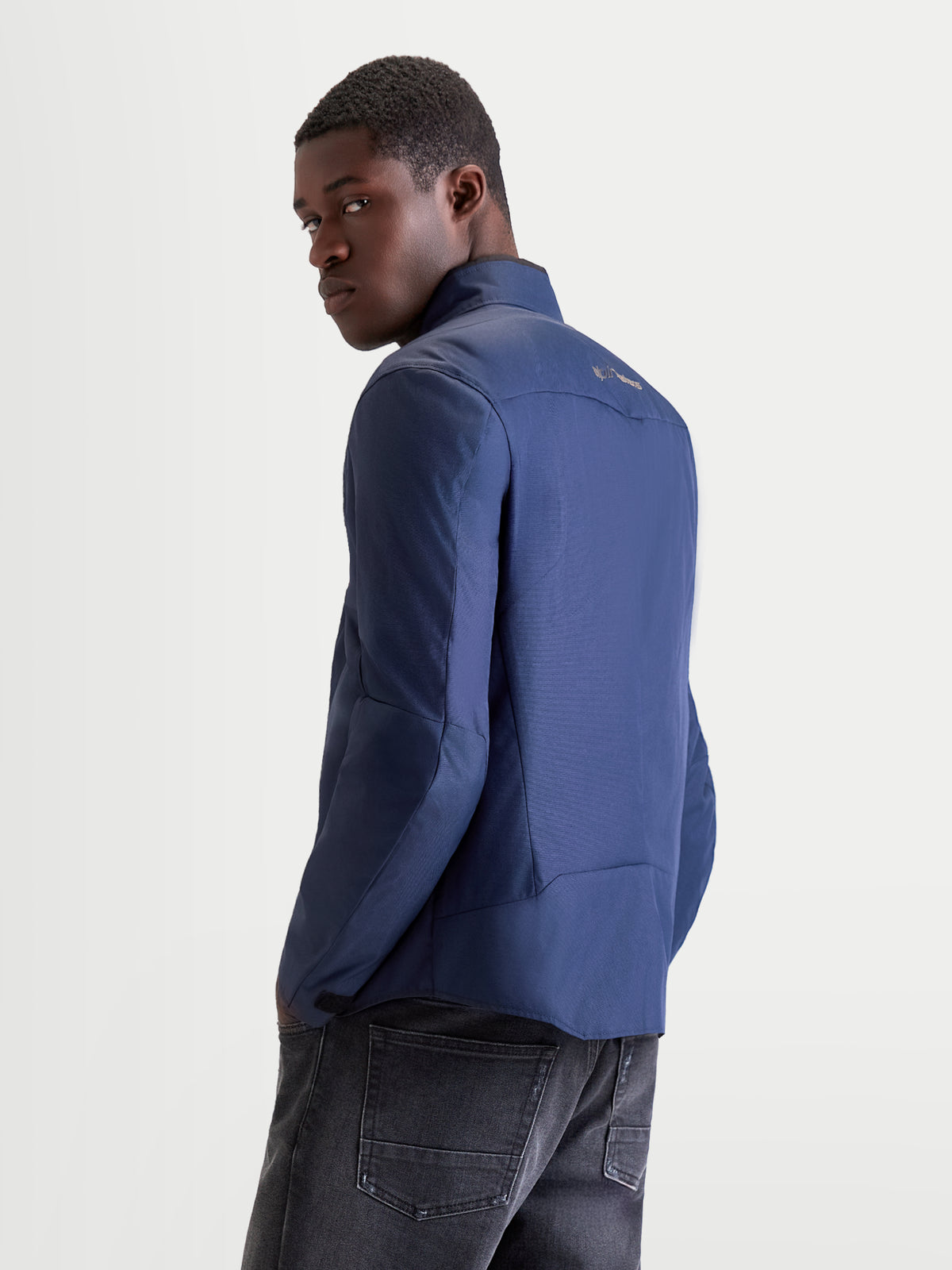 Alpinestars C-1 Waterproof Jacket, men's urban contemporary motorcycle textile jacket in dark blue, rear-quarter view showing 450D polyfabric construction and ergonomic 3D back pattern worn by a model.