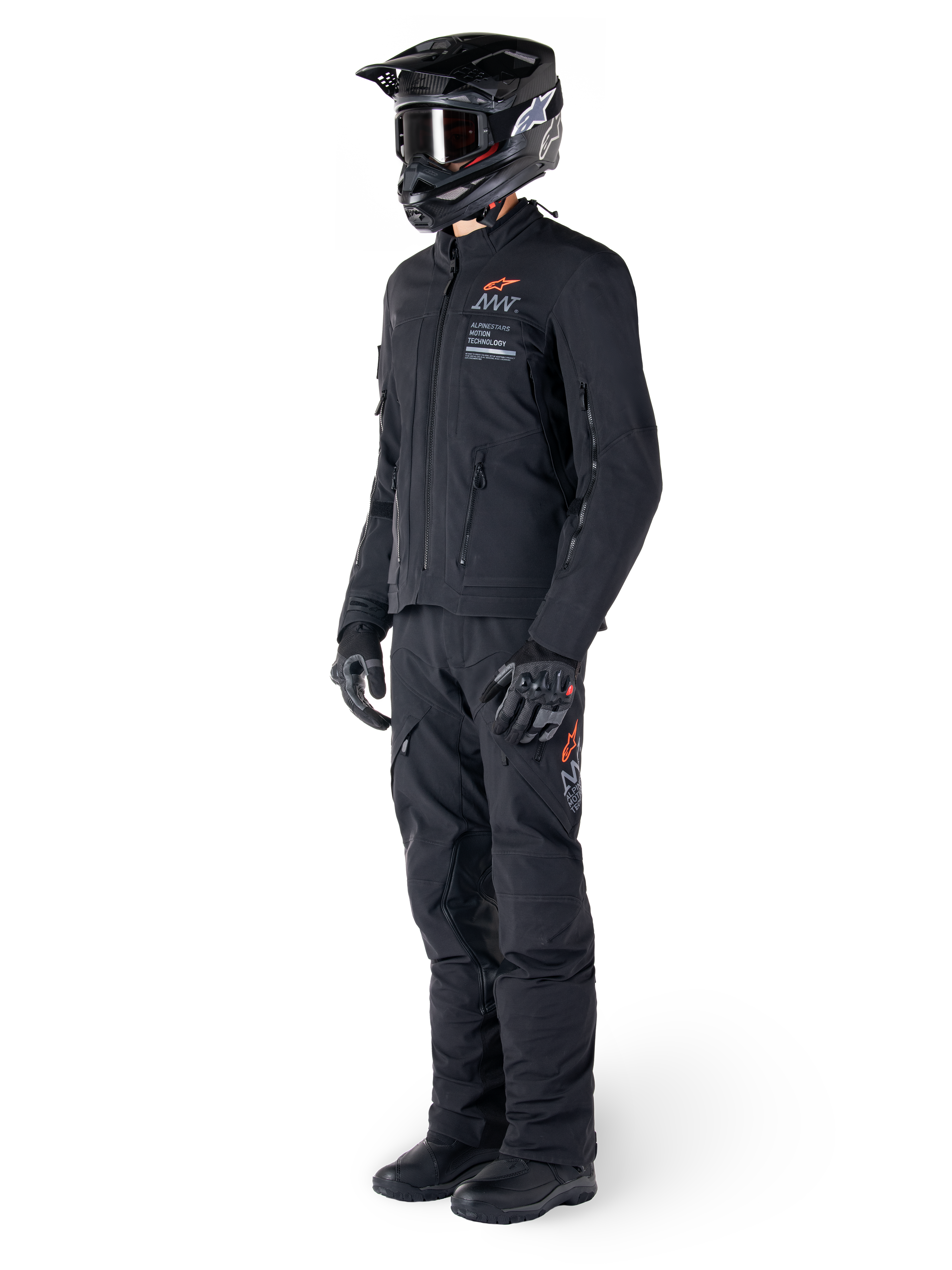 Alpinestars AMT-8 Stretch Drystar® XF Jacket, Adventure Motorcycle Jacket, Black, worn with matching pants, helmet, and gloves, featuring Alpinestars Motion Technology branding with orange accents, durable stretch construction for adventure riding