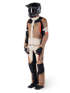 Alpinestars ST-1 Waterproof Jacket, Dark Khaki Sand Black Red Fluo, worn by a rider in full adventure touring gear with matching pants, black helmet, goggles, gloves, and boots, technical all-weather motorcycle outfit