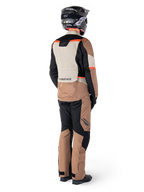 Alpinestars ST-1 Waterproof Jacket, Adventure Touring Jacket, Dark Khaki Sand Black Red Fluo, Rear view worn with matching pants and black helmet, featuring color-blocked panels and red fluorescent accents.