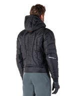 Alpinestars Mohobbs Waterproof Jacket, Black, rear view showing quilted padded construction, hood, vertical astars wordmark on the back, and Alpinestars branding on the sleeves, worn with grey pants and black gloves.