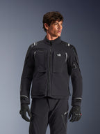 Alpinestars Andes Pro Drystar® XF Jacket, black and dark gray motorcycle adventure touring jacket, worn with matching pants and gloves, featuring technical laminated shell construction, ALL TERRA chest logo, reflective details, and adjustable cuffs
