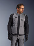 Alpinestars Andes Pro Drystar® XF Jacket in Dark Gray and Black, adventure riding gear, worn by a man with coordinated gray pants and black gloves, featuring a 3-layer laminated shell, utility pockets, and 'Terra' logo on the chest