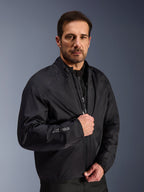 Alpinestars Cusco Drystar® Jacket, Black waterproof membrane layer worn by a male model, featuring Drystar logo on the sleeve, lightweight adventure touring motorcycle gear